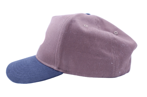 Two-tone cap with purple front and black back on a white background